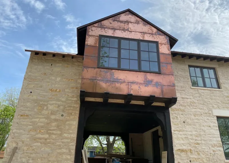 Copper metal panel facade on a stone building for Skylight Installation in Poquoson
